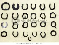 stock-photo-twenty-five-different-types-of-old-horseshoes-lined-up-in-rows-against-a-pale-cre...webp
