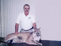 Leo with big cat in Florida.webp