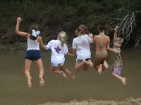 jumping%20in%20creek.webp