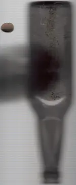 Bottle and bent dime.webp