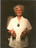 Letha holding gold bars.webp