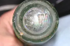 Coke bottle bottom view.webp