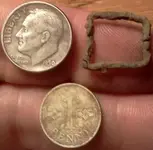 1950 silver dime, forein silver penni, and tiny buckle.webp