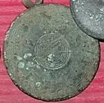 Tombac Button.webp