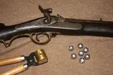 brunswick-rifle-with-mold-and-belted-balls[1].webp