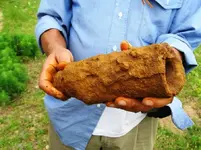 02. Dan holding unknown object that looks like a small cannon.webp