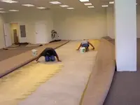 Cesar and Carlos troweling glue.webp