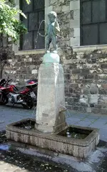 Aachen, Germany Boy Holding Fish Fountain.webp