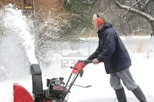 3968617-man-using-a-snow-blower-in-winter.webp