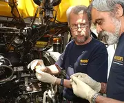 Treasure hunters examine coins.webp