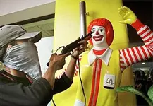 demonstration_-_muslim_protester_points_his_toy_gun_at_ronald_mcdonald.webp