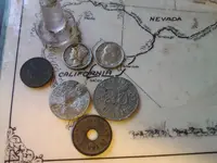 Mercury dime,roosevelt dime and three old tokens front side.webp