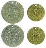 Original_coin_and_replica_used_as_ornaments.webp