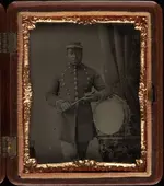 Three_quarter_length_portrait,_soldier_with_bass_drum,_holding_sticks._Cased_tintype,_gutta_p...webp