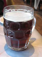 British_dimpled_glass_pint_jug_with_ale.webp