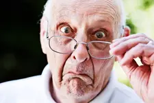 Grumpy-old-man-looks-over-spectacles-shocked-and-disapproving-2289475.webp