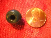 17th Century Dutch glass trade bead (with  penny for scale).webp