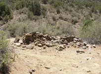 stone_haus_on_bank_of_dry_wash.webp