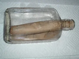 Bottle with a note inside 5 to 6 inches deep in the ground.
