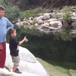 Grandson Ryden learning to fish from Rodney