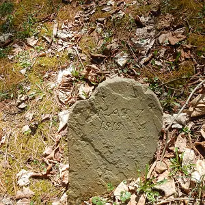 Original worn sandstone foot stone.