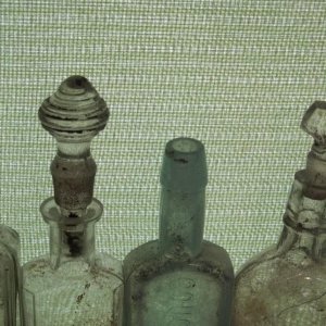 A few bottles with some glass stoppers that were surface finds found while detecting.