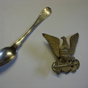 An 1825 83% silver Swedish spoon and a 1930's United States Coast Guard Hat Badge
