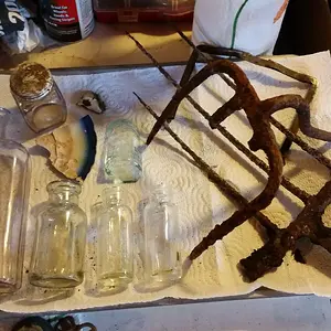 Bottles, farm tools, & part of a clutch/coin purse.