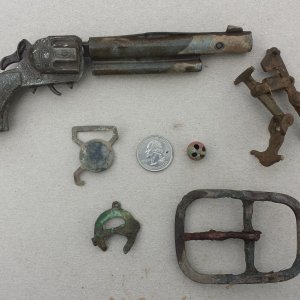 20150927 A collection of relics found on private property in Madison. Included are a 1950s era toy pistol, a suspender buckle, a large buckle and a sm