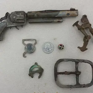 20150927 A collection of relics found on private property in Madison. Included are a 1950s era toy pistol, a suspender buckle, a large buckle and a sm