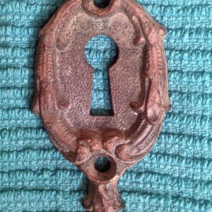 Skeleton key plate from early 1900's found in a parking lot of an old building downtown.