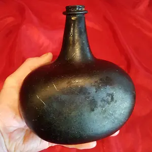 18th century black glass liquor/wine bottle with flat front
