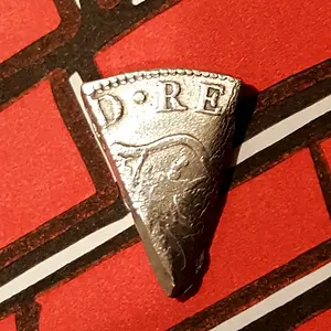 Cut 1772 Spanish eight reales silver coin.  This piece is one eighth of the original coin and would have been worth one real.  Also referred to as a "