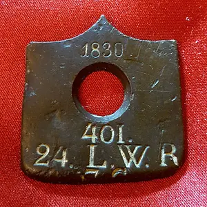 Partial butt plate from a Prussian musket.  Issued in 1830 to a Prussian soldier (in Germany) in the 24th Landweir Regiment (7th Company); repurposed 