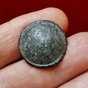 Pewter coat button dug from a creek