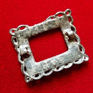 Pewter knee buckle dug from a creek; has a "TS" maker's mark on the back side