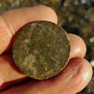 King George II half penny.  The date is worn off but it has the "old head" bust which puts it in the range of 1740-1754.