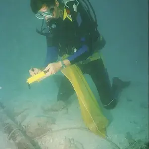 Syd Jones, near the Atocha main pile with some ballast stones scattered about.  The main pile, relocated as they searched in and under the ballast for