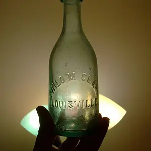 Blob Top Squat Soda Bottle, 1860-63 - The bottle was dug from a cellarhole, and it is marked "PHILO M. CLARK / LOUISVILLE KY."