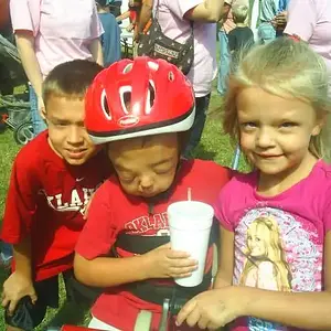 Hunter and his big brother Jacob and little sister Kirstin when he was presented with his own AMTRAC tryke