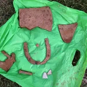 Axe head, part of a plow, horse shoe, marble, large square peg or bolt, some broken pottery and something else I can't quite figure our.  Will repost 