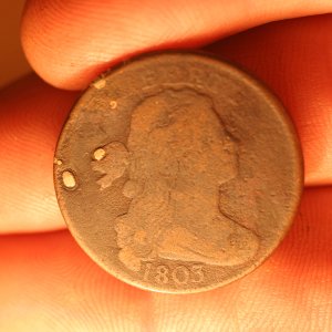 odd large cent with impressed
silver colored metal.