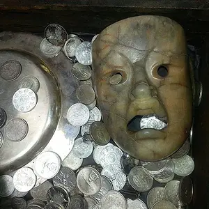 The treasure chest was filled with many silver coins.