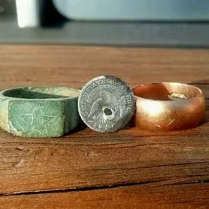 Brass regimental ring, gold ring, and 1820 half dime found in one day.