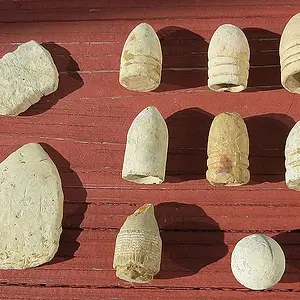 A few of the different types of bullets including two poker chips.