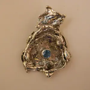 Water cast sterling silver pendant with swiss blue topaz