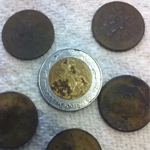 First Peso in a pocket spill of dimes.