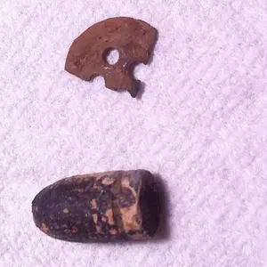 Piece of button and a Bullet..