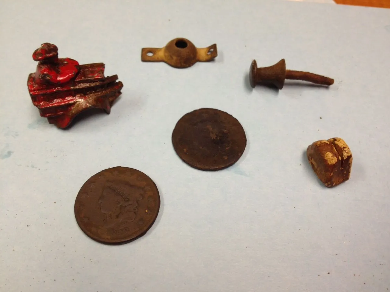 2 Large Cents (one from 1828)
toy fire truck
home made lead sinker
metal push pin (early 1900's)
possibly a window shade holder