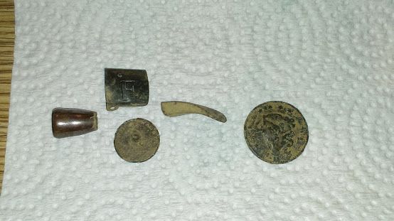 50 cal slug. Suspender clip, 1800's Wallace flat button, Gun trigger, 1827 Large cent.  
   Northville